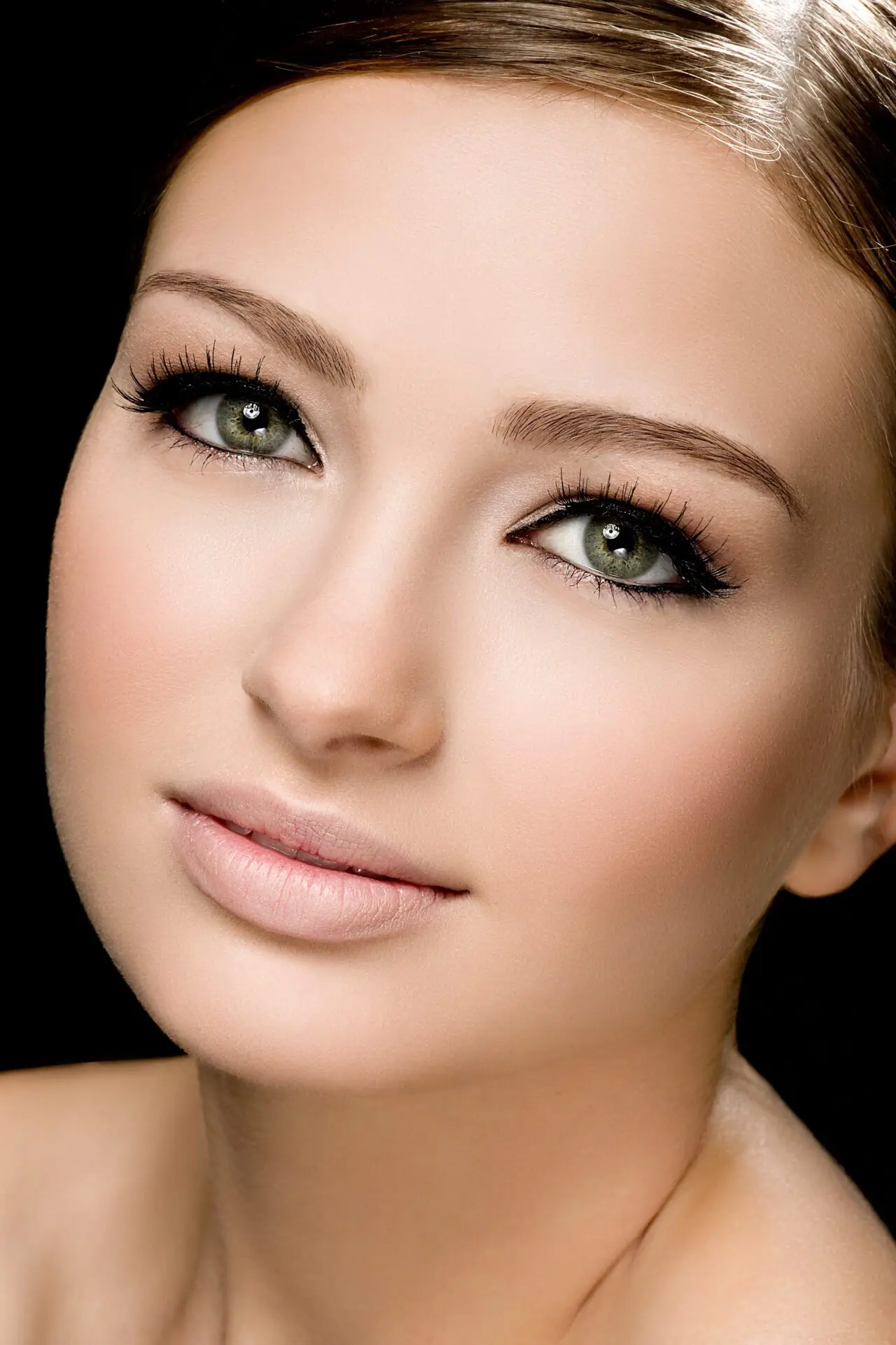 Young woman relaxing with cosmetic mask on face at beauty salon- indoors